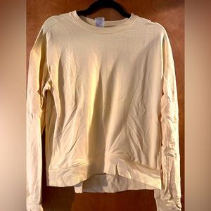 Pale yellow long sleeve activewear top